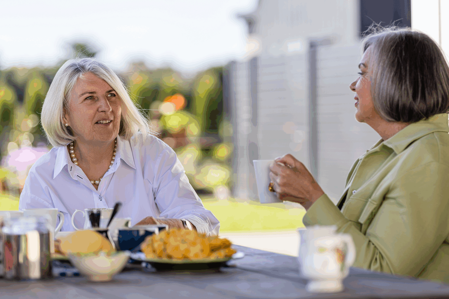 two women talking and having a cup of tea