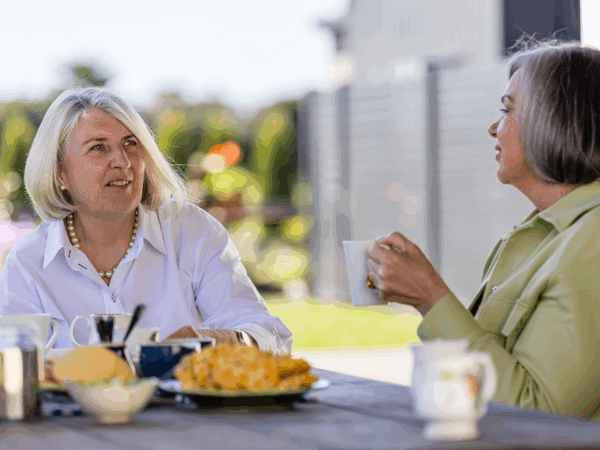 two women talking and having a cup of tea